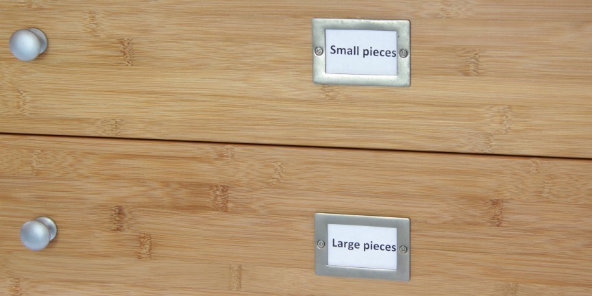 silver-coloured knobs and badges of drawer